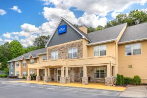 a hotel with a sign on the front of a building at Baymont by Wyndham Kennesaw in Kennesaw