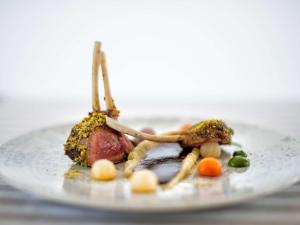 a plate of food with meat and vegetables on it at Almar Timi Ama Resort & Spa in Villasimius