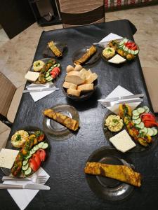 a black table with plates of food on it at Guesthouse different in Tbilisi City