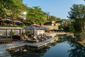 a resort pool with lounge chairs and umbrellas at Andaz Costa Rica Resort at Peninsula Papagayo – A concept by Hyatt in Culebra