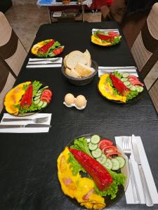 a black table with plates of food on it at Guesthouse different in Tbilisi City