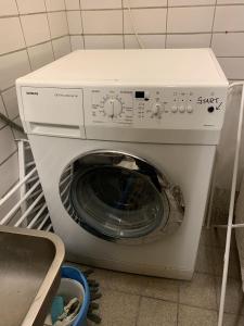 a white washing machine in a kitchen with at Appart S plus 2 à Sousse zone touristique in Sousse +5 photos