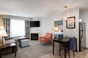 a living room with a room with a hotel room at Homewood Suites by Hilton Boston/Andover in Andover