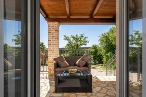 a patio with a couch and a table at Madonna delle Nevi in Oprtalj +37 photos