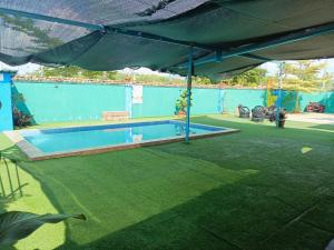 a swimming pool under a tent in a yard at Homestay Megat & Puteri in Kampong Tanjong Putus