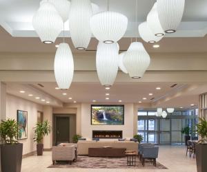 a lobby with white chandeliers in a hotel at Hilton Garden Inn Philadelphia Center City in Philadelphia