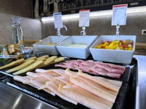 a bunch of meats and other foods on a grill at ibis budget Coutances in Coutances