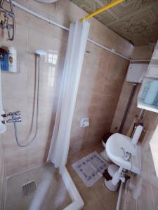 a bathroom with a shower and a toilet and a sink at Traditional Maltese townhouse in Rabat in Rabat