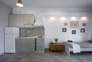 a kitchen with a sink and a bed in a room at Azure Nikiti in Nikiti