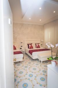 a hotel room with two beds and a room with two tables at Hotel San Pietro in Maiori