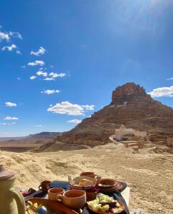 a tray of food on a table in the desert at Ecogite Guermessa in Ghomrassen