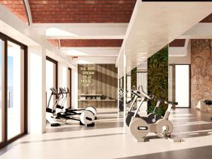 a gym with treadmills and elliptical machines at Cala San Miguel Hotel Ibiza, Curio Collection by Hilton, Adults only in Puerto de San Miguel