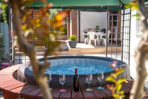 a hot tub with glasses and a bottle of wine at Palmira Apartments in Poreč