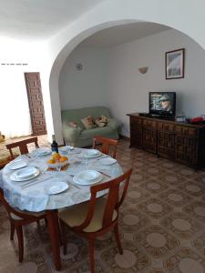 a dining room with a table and a couch at BEAUTIFUL APARTMENT COSTA BLANCA PRIVATE POOL! in Oliva