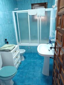 Baño azul con aseo y lavamanos en BEAUTIFUL APARTMENT COSTA BLANCA PRIVATE POOL!, en Oliva