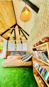 1 dormitorio con suelo verde y 2 camas en Kijani Cottages - In Diani en Diani Beach