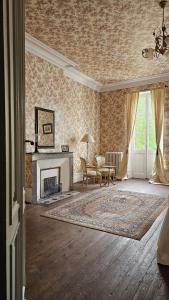 a living room with a fireplace and a couch at Domaine La Gazaille de Camille in Le Temple-sur-Lot +49 photos