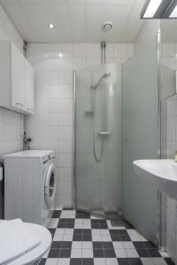 a bathroom with a shower and a washing machine at Live and Stay Lagerbring in Gothenburg