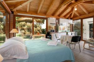 a bedroom with a bed and a table and a kitchen at Palmira Apartments in Poreč
