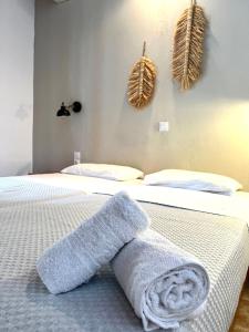 a bedroom with a bed with a towel on it at Panos Villas in Koukounaries