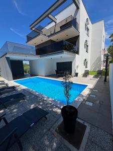 a house with a swimming pool in front of it at Residence Bella Vista in Bibinje