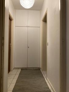 a hallway with white cabinets and a rug at Molino Nuovo in Vacallo