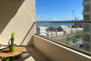 a balcony with a table and a view of a city at Grandstay Portside in Durrës