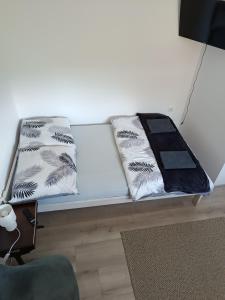 a couch with two pillows sitting on it at Staś-przy szkole nr3 w Skawie in Skawa +6 photos
