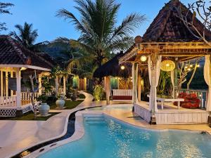 a resort with a swimming pool and a gazebo at Janur Bungalow in Borobudur