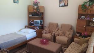 1 dormitorio con 1 cama, 1 cama y 1 silla en Spring Village Home, en Përmet