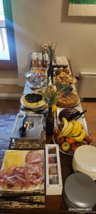 a long table with many different types of food at Tenuta Le Garzaie - Villa Furlo in Fermignano