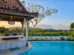 a view of a swimming pool at a resort at Janur Bungalow in Borobudur