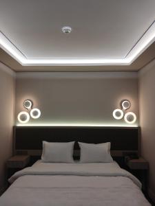 a bedroom with a bed with two lights above it at Theodosius Hotel in Istanbul