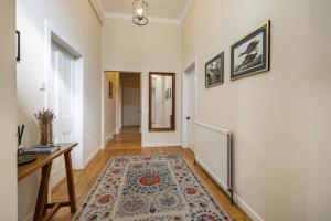 a hallway with a table and a rug at Lower Tweedknowe - ground floor villa Melrose in Melrose
