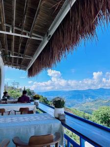 a restaurant with a view of the mountains at Nontawa Villa & Cafe in Ban Huai Khai