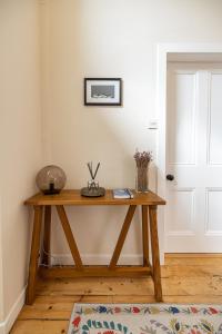 梅爾羅斯的住宿－Lower Tweedknowe - ground floor villa Melrose，木桌,位于带门的房间
