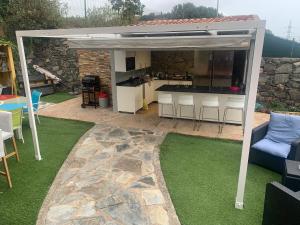 a pavilion with a kitchen in a backyard at Villa Mirador Los Hoyos in Las Palmas de Gran Canaria
