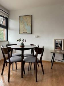 a dining room table with chairs and a map on the wall at 1BR Apartment - Walk to City (1 Queen Bed) in Hobart