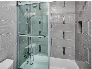 a bathroom with a glass shower and a bath tub at Manhattan skyline under your feet in North Bergen