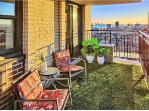 a balcony with two chairs and a table on a balcony at Manhattan skyline under your feet in North Bergen