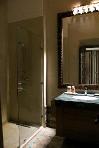 a bathroom with a shower and a sink and a mirror at Villa Magnolia - Amelkis Golf in Marrakech