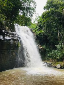 a waterfall in the middle of a river at River Splendour Home Stay in Ella