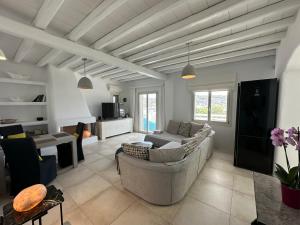 a living room with a couch and a table at Grace Villa Mykonos in Mýkonos City