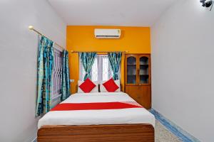 1 dormitorio con 1 cama con almohadas rojas en OYO Flagship The Image A Quality Stay en Calcuta