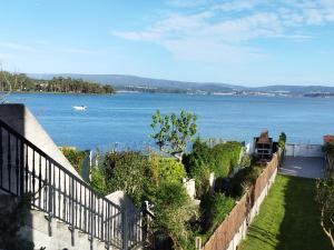 a view of a large body of water from a house at Vistas Al Mar E Isla De La Toja in O Grove