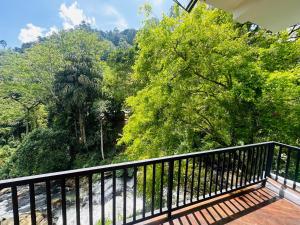 a balcony with a view of a river and trees at River Splendour Home Stay in Ella