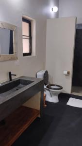 a bathroom with a sink and a toilet at Joma Adventure Lodge in Senga
