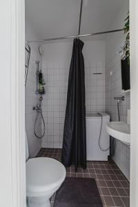 a bathroom with a shower and a toilet and a sink at Nordstay - Trendy Studio by the North Harbor self check-in in Helsinki