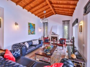 a living room with a couch and a table at VILLA SCARLETT in Kaş