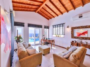 a living room with two couches and a table at VILLA SCARLETT in Kaş